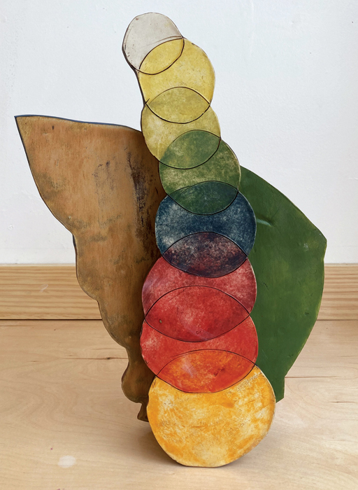 1 Gabriela Vainsencher’s A stage, complete with a sofa, curtains, a large ear, and someone who has yet to make an entrance (front), 15 in. (38 cm) in height, porcelain, glaze, underglaze, 2022. 
