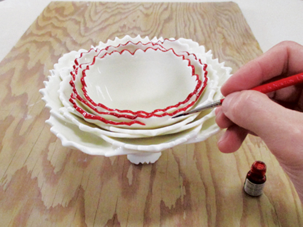 17 After the glaze firing, carefully paint gold luster onto the rim of each layer with a thin brush.