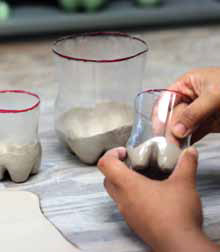 1 Cut plastic bottles, apply a mold resist, then fill the inside of the mold with slabs.