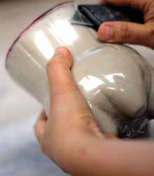 2 Cut away the plastic mold carefully, avoiding any damage to the clay wall.