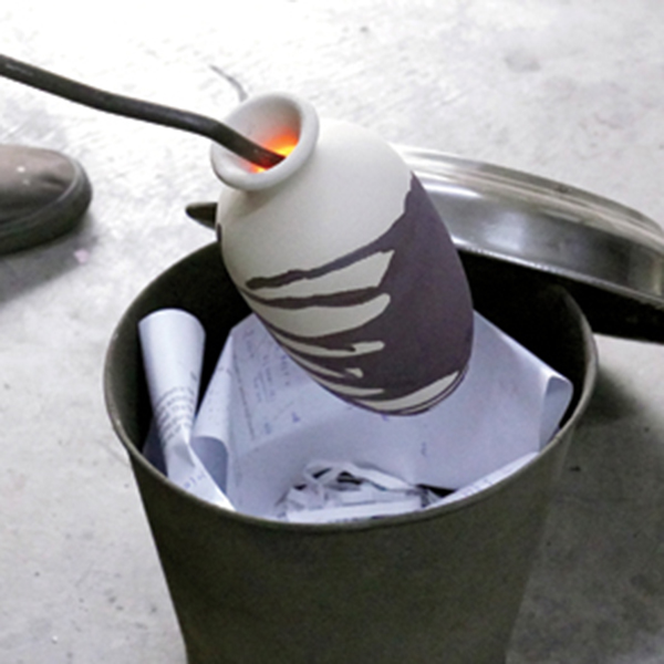 7 Once the red-hot piece is out of the kiln, quickly place it into the combustion chamber.