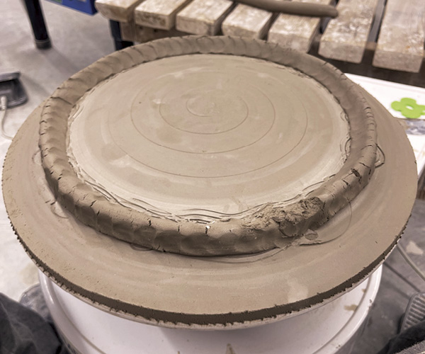 8 Attach a coil where the well meets the lip of the plaster mold.