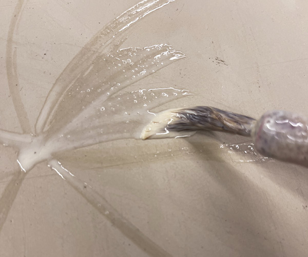 11 Use a brush to decorate surface with wax resist.