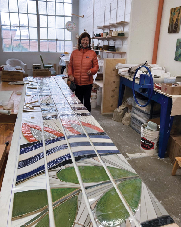 4 Aileen Barr at her studio laying out handmade tile and mosaic step panels for the Waymark Mosaics at Walnut Creek, California, 2021. 