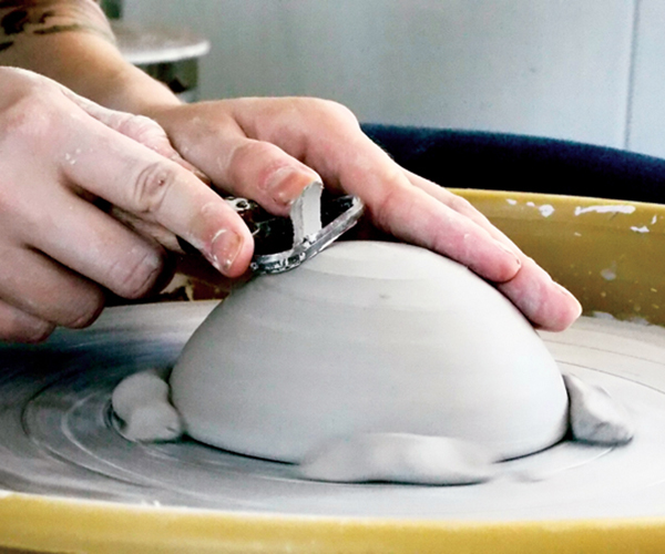 6 Once the bowl reaches soft leather hard, trim it to have a rounded bottom, then smooth the form.