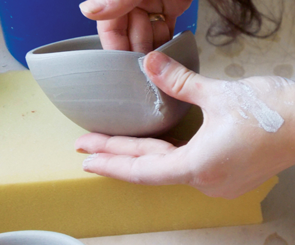 8 Overlap the darted area, then slip and score the two sides. Use your fingers to compress them together.