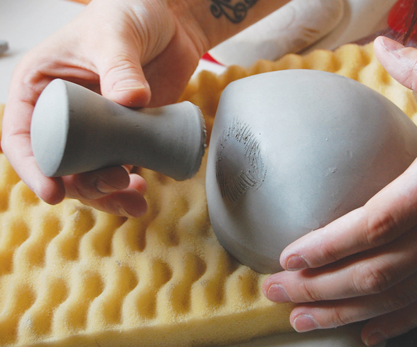 9 Experiment with handle placement. Slip and score the handle into place. Clean up any marks and lightly sponge the seams.