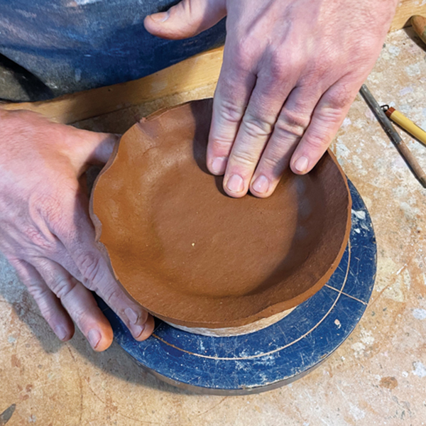 3 Roll out a slab and push it firmly into the mold to attach it to the scored foot. 
