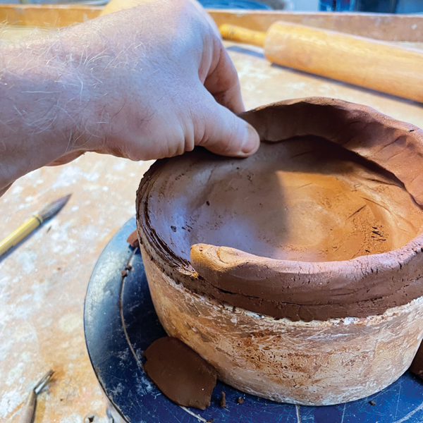 4 Score the top of the base slab to ensure a strong attachment and then compress and smooth the first coil onto the base. 