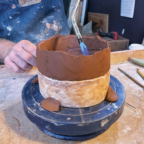 7 Use a torch to heat the interior and exterior of the walls about an inch from the top. This will dry the wall a bit so that it can support the weight of added coils. 