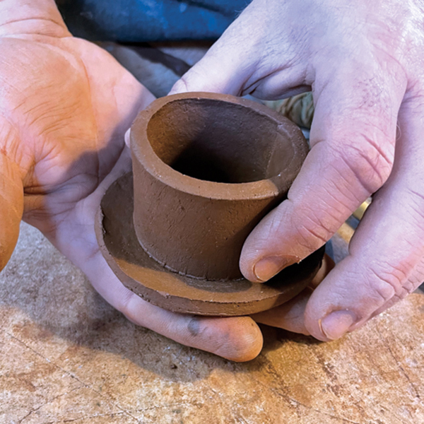 9 Add a cylindrical slab flange to the bottom of the leather-hard lid. The flange will keep the lid in place while pouring from the teapot.