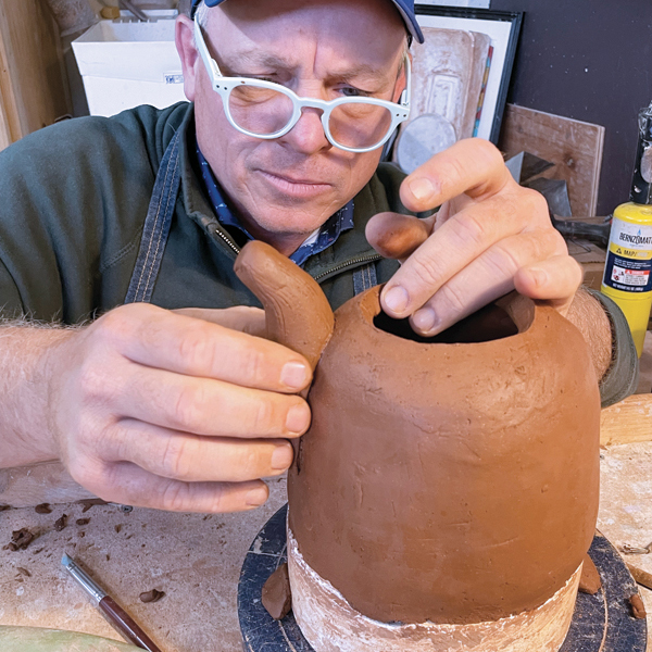 12 Score the attachment area, apply slip, then attach the spout, making sure it is straight and secure.