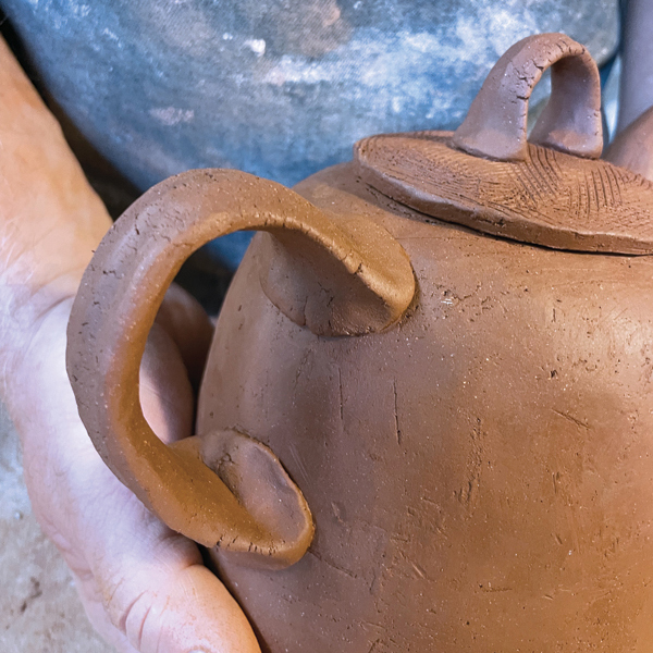 15 Attach the handle, paying close attention to the interior curve so that it will be comfortable to hold and will balance the weight of the teapot when in use.