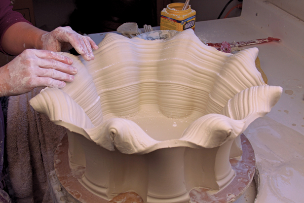 12 Fold out then score and slip the remaining sections of rim to close the flaps.