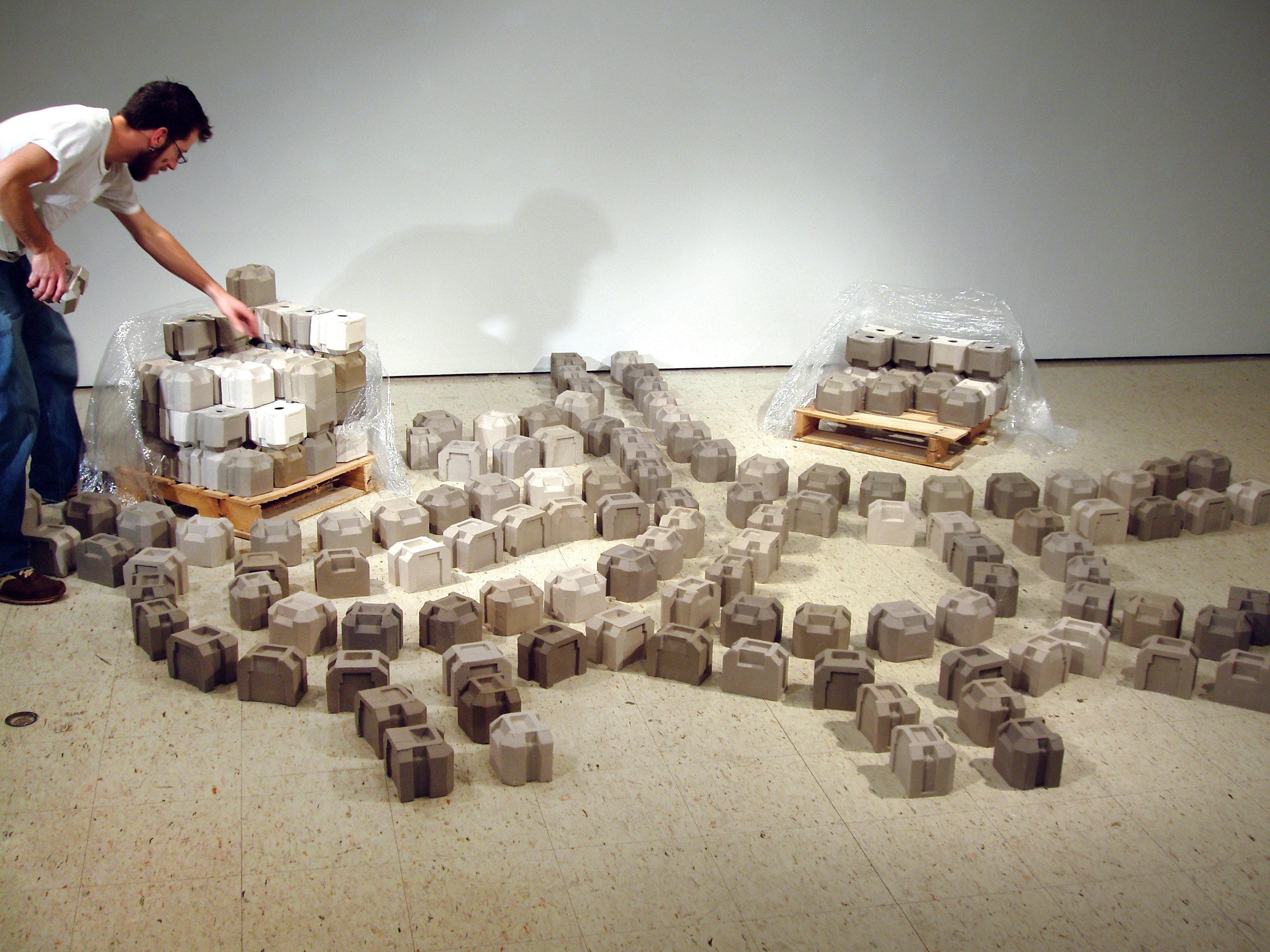 Boomburb, variable dimensions, colored porcelain, wood, stretch wrap, 2005.