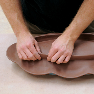 5 Be sure the rim sits parallel to and several inches above the table. Add a foot to the bottom and allow it to firm up.
