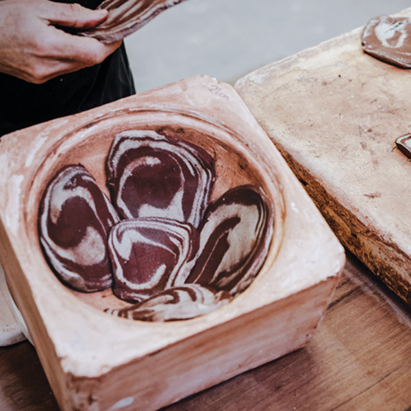 6 Cut the marbled clays into 1/3-inch (8mm) thick slices, then press them into a plaster mold to form the walls of a vessel. 