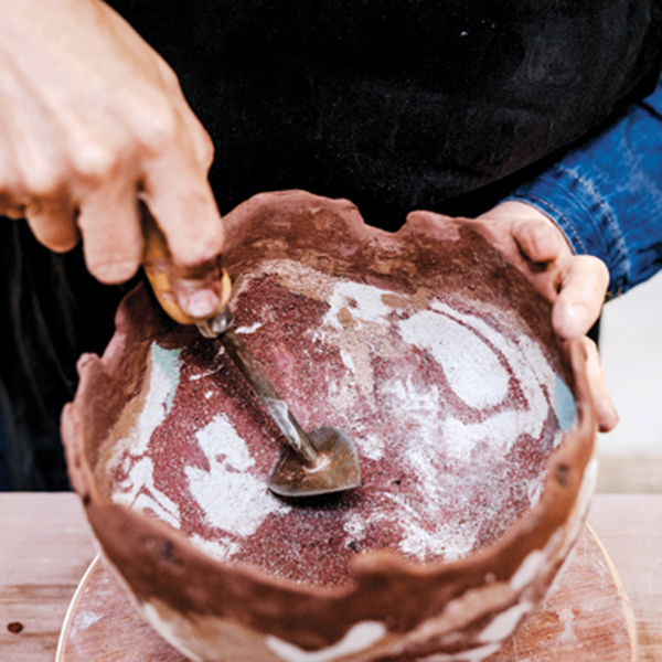 11 Carefully remove the dried piece from the mold. Scrape the interior to reveal the crisp marbled texture and the small areas of found materials beneath the marred surface.