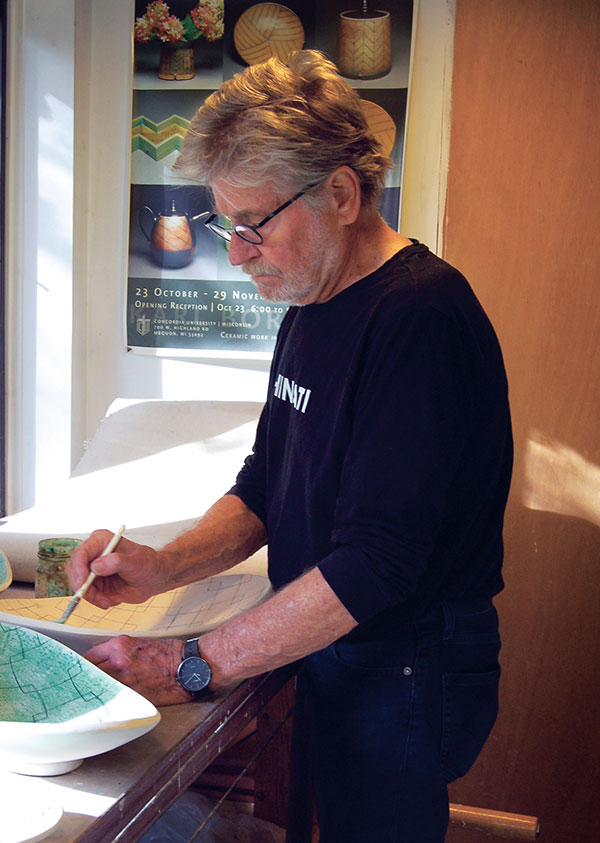 4 Karl Borgeson painting wax on a tray.