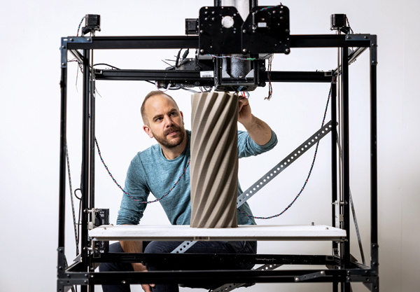 3 Brian Peters in his studio with one of his ceramic 3D printers.