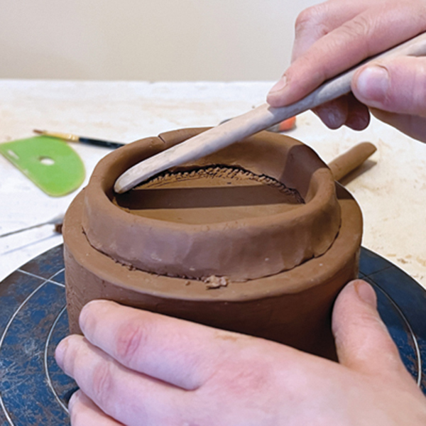 5 Score, apply slip, and add a coil. Blend the inside and outside to the bottom slab.