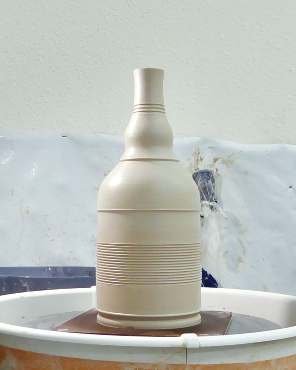 3 Using various ribs and leather-working tools, add textures, sections, and a foot.