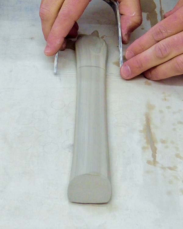 6 Pull a handle, lay it on the table, and cut two parallel angles into the ends.