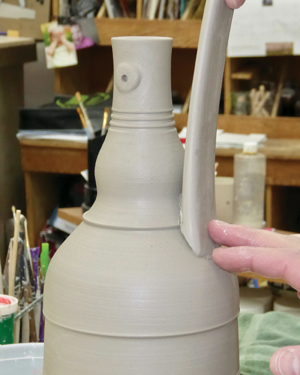 7 Attach the bottom of the handle to the shoulder and bend it over to form a strap.