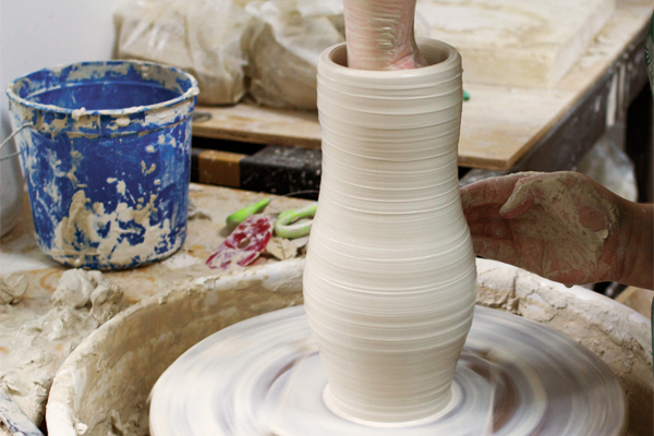 1 Throw a tall, narrow cylinder with 3½ pounds of clay, then push out the form from the inside.