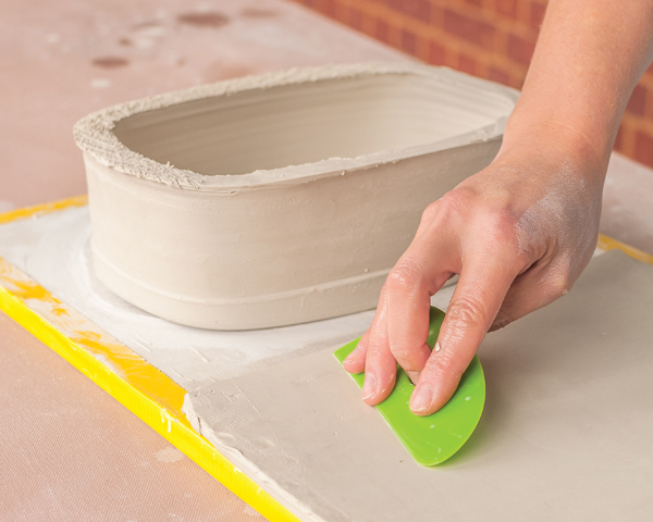 4 Roll out a slab, compress both sides, then place it onto a drywall board.
