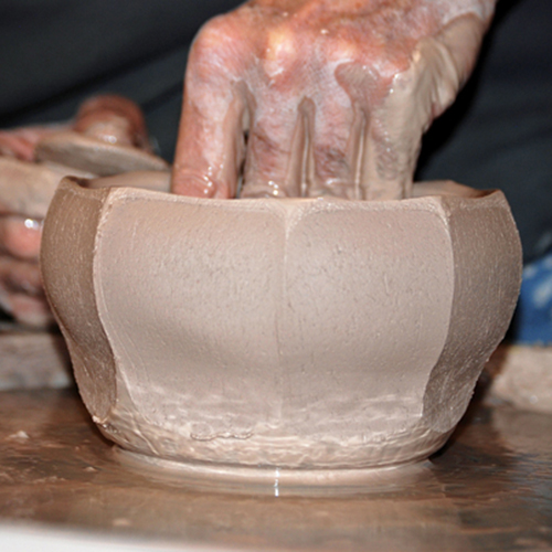 3 After cutting straight facets, use your inside hand to flare out the wall to a desired bowl shape. Try not to touch the outside.