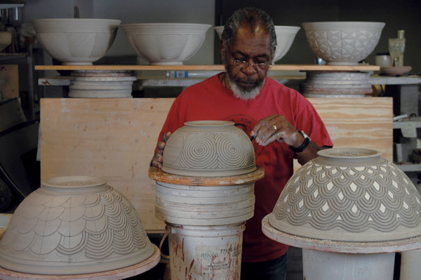 2 David MacDonald working in the studio developing carved surface patterns on bowls.