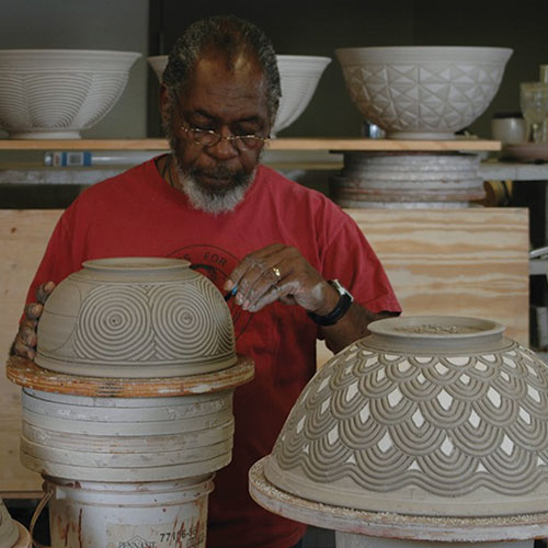 David MacDonald carving a pot.