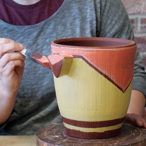 5 Brush on a second color to select areas of the piece. Leave some areas bare to let the raw clay body show through.
