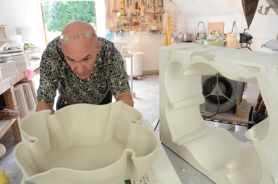 1 Andrew Martin cleaning up a vessel after removing it from a plaster mold.