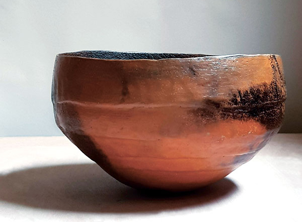 6 Smoke-fired bowl, 8 in. (21 cm) in diameter, white stoneware, terra sigillata made from local clay collected by the artist, 2019. 