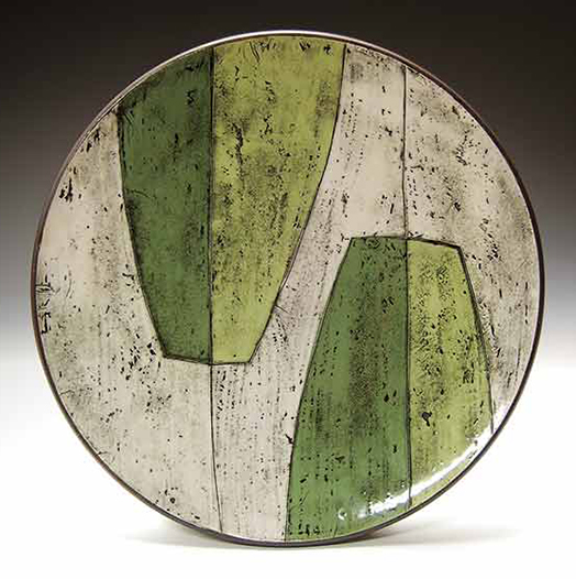 6 Platter with Greens, 12 in. (30 cm) in diameter, dark-brown stoneware with monoprint slip transfer, fired to cone 5 in oxidation, 2022. 