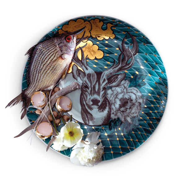 1 Melanie Sherman’s platter with deer, clouds, fish, antlers, eggshells, and flowers, 16 in. (40 cm) in diameter, porcelain, glaze, overglaze, gold luster, found objects, 2015. Photo: EG Schempf.