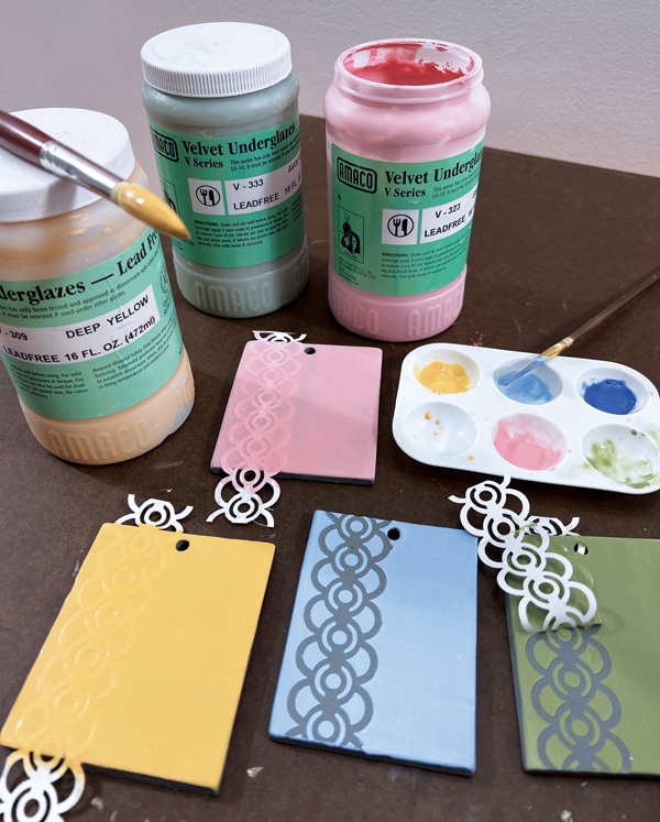 1 Process shot of paper stencils and underglaze applications on test tiles. 
