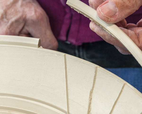 2 Make at least two passes with a single-edge razor blade to cut through the rim of the bowl.