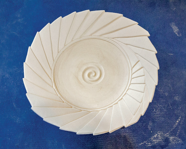 7 Finished carved piece showing the depth of carving and shadows of the piece.