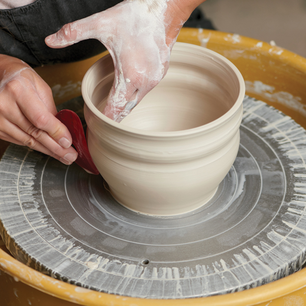 6 Trim the base, then smooth the form with a soft rib.