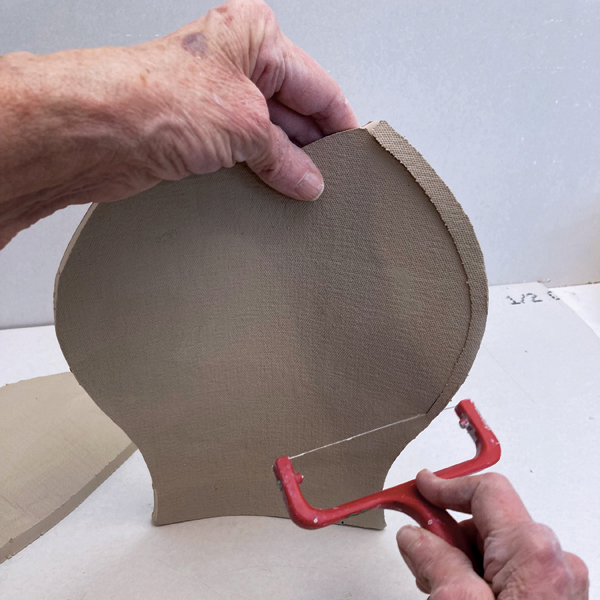 2 Use a cheese slicer to miter the edges of the vertical sides. Do not miter the top or bottom edges.