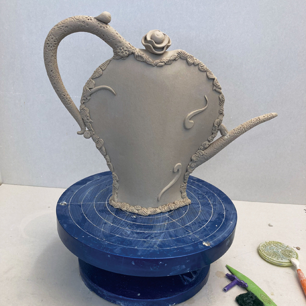 9 Ensure all pieces are well attached, and allow the pot to dry before bisque firing.