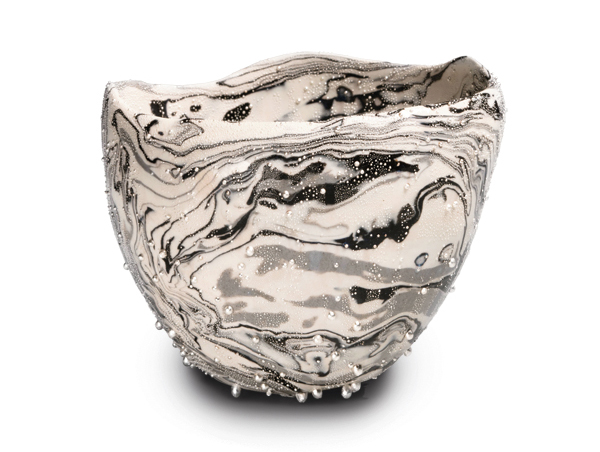 1 Kondō Takahiro’s Ginteki wan Nami (Wave teabowl with “silver mist” glaze), 5½ in. (14 cm) in height, marbleized porcelain, artist-developed “silver mist” overglaze, 2021. Photo: Richard Goodbody. Courtesy of Joan B Mirviss LTD.