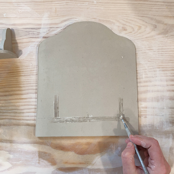 8 Score and slip the back piece and back edge of shelf and side brackets.