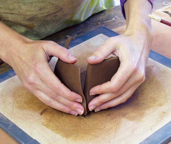 4 Gently tack the slabs together from bottom to top all around the pot. Use a rubber brayer or rib to secure the slabs.