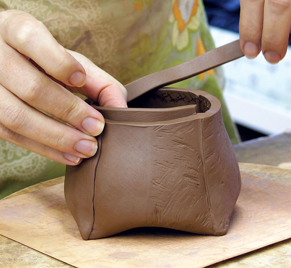 8 Finger tack a thin slab around the inside rim of the pot. The flange only needs to be slightly higher than the top of the pot to hold the lid in place.