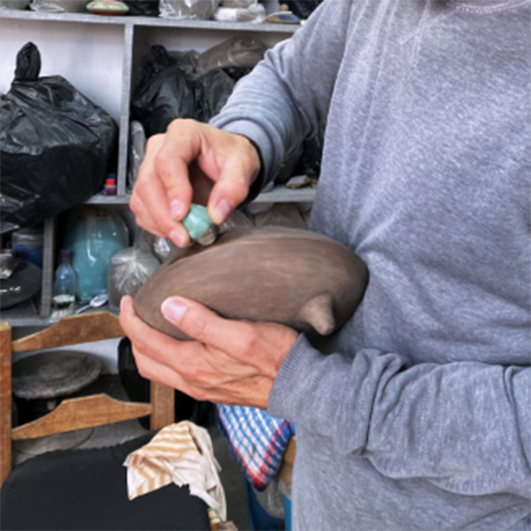 5 Burnishing the surface of a churumbela armadillo with a polished piece of iron pyrite.