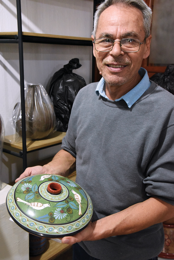 G Cortez holding one of his fired churumbela vase forms with traditional Tonalá imagery. Photos: Richard Burkett and Joe Molinaro.